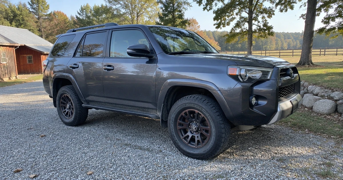 All Terrain Tires for SUVs are fitted to a parked SUV on a gravel lane