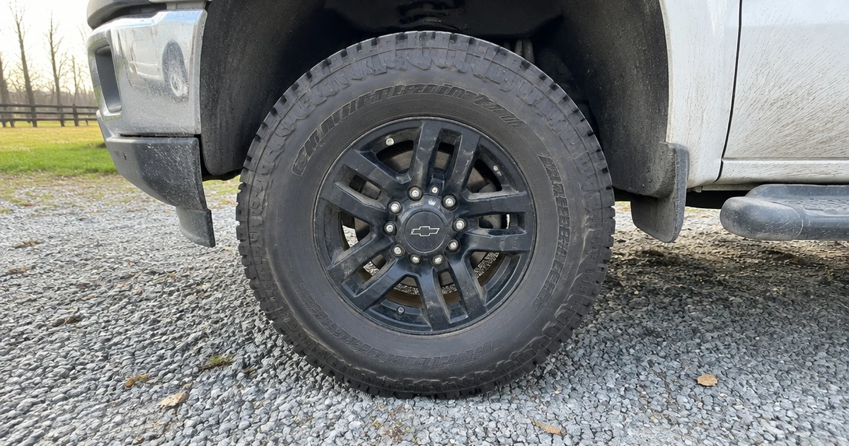 Light Truck Tires mounted on a work pickup parked on a gravel driveway