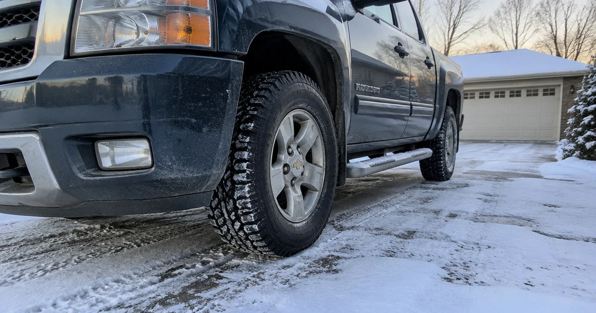 A pickup parked on a snowy driveway with Snow Tires for Trucks fitted