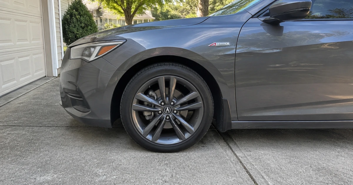 A close view shows tires for Acura Integra fitted to a parked car