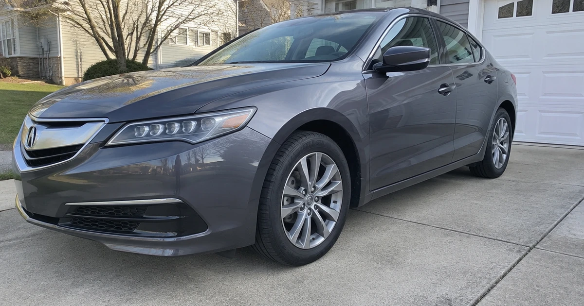 A sedan wears tires for Acura TLX while parked outside on a residential driveway