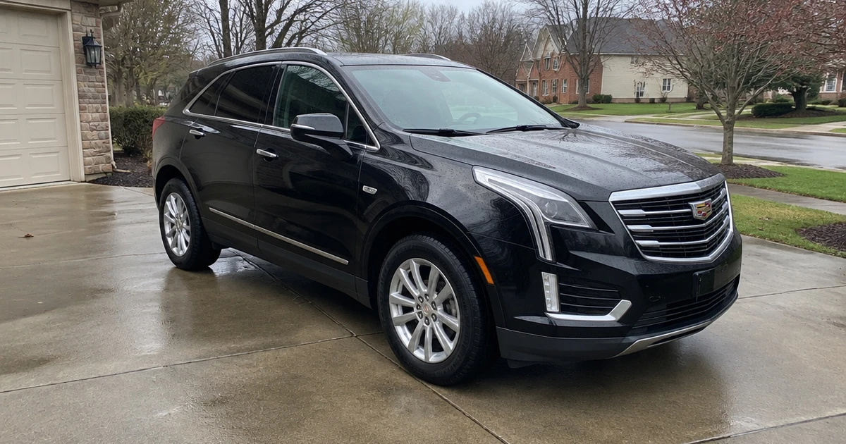 A Cadillac XT5 sits on tires for Cadillac XT5 in a driveway