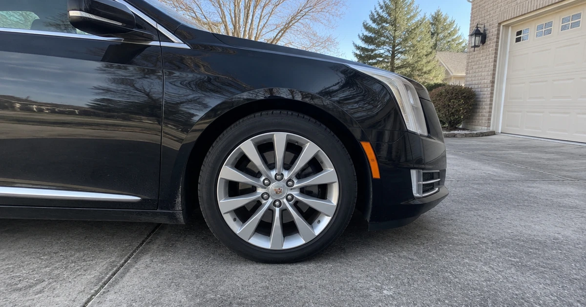 A mounted tire on a Cadillac XTS shows everyday tires for Cadillac XTS in daylight