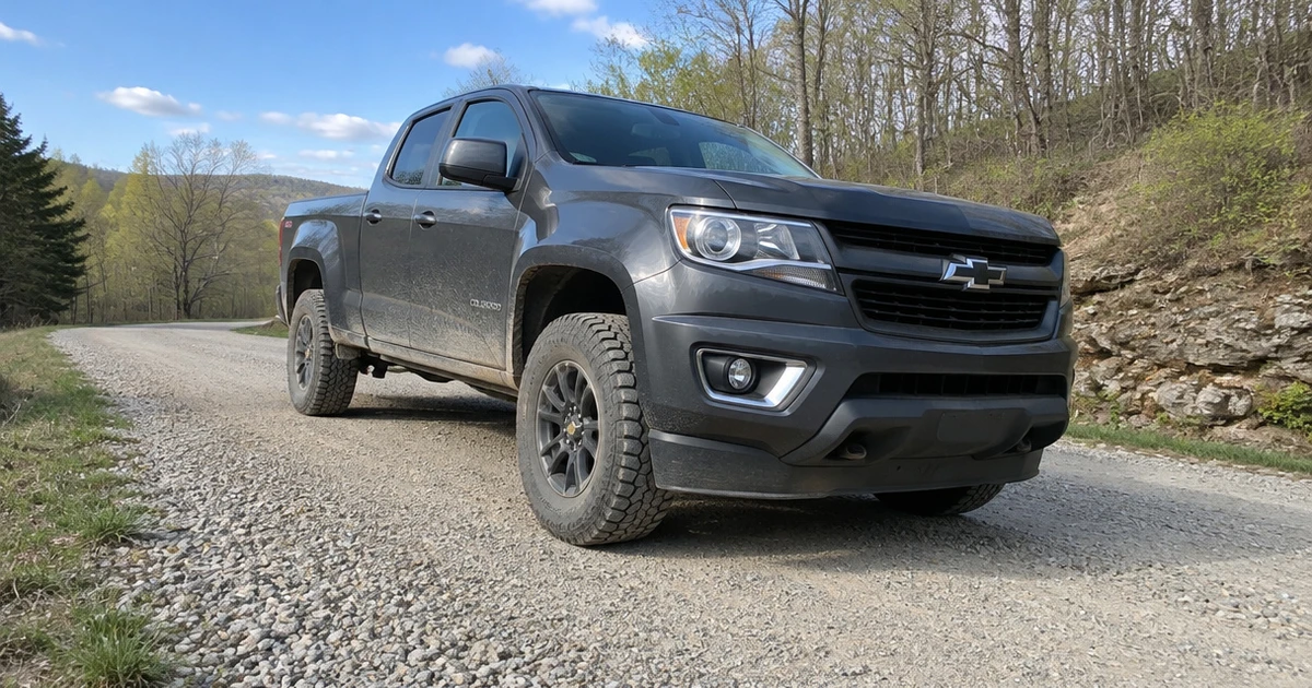 A Chevy Colorado on a gravel road with tires for chevy colorado clearly in view