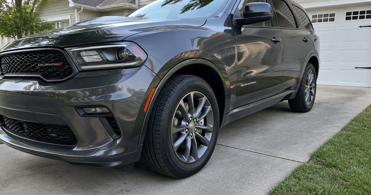 A Dodge Durango parked on a driveway with tires for Dodge Durango fitted