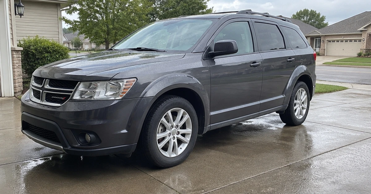 A Dodge Journey parked in a driveway shows its fitted tires for Dodge Journey