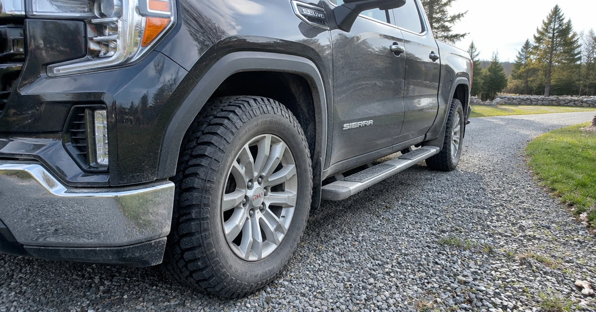 Close view of tires for GMC Sierra 1500 fitted to a pickup in a driveway