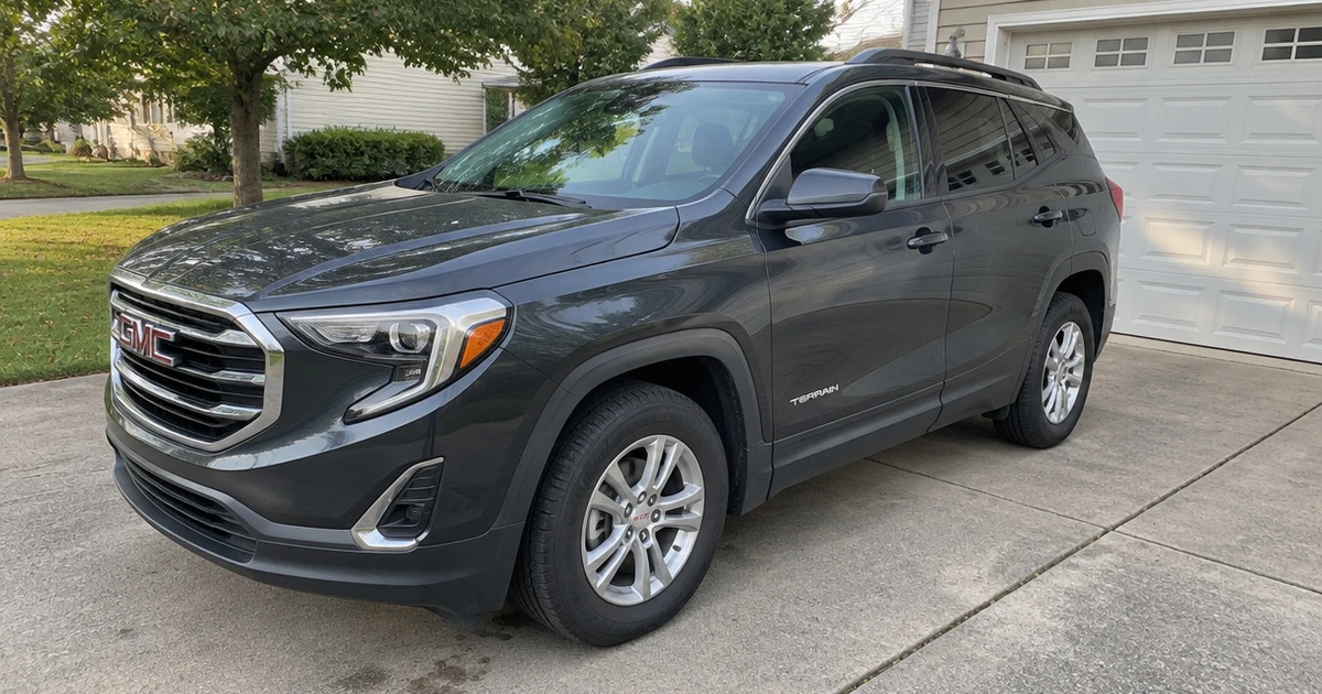 A GMC Terrain on a driveway shows one tire for GMC Terrain in daylight