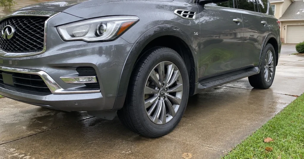 Tires for Infiniti QX80 sit on the SUV outside a suburban home