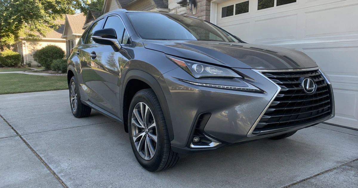 A Lexus NX parked on a driveway with tires for Lexus NX clearly visible