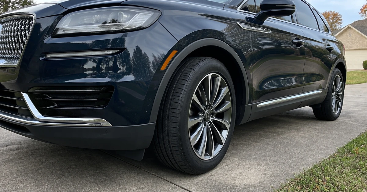 A Lincoln Nautilus sits on a driveway, showing tires for Lincoln Nautilus in profile