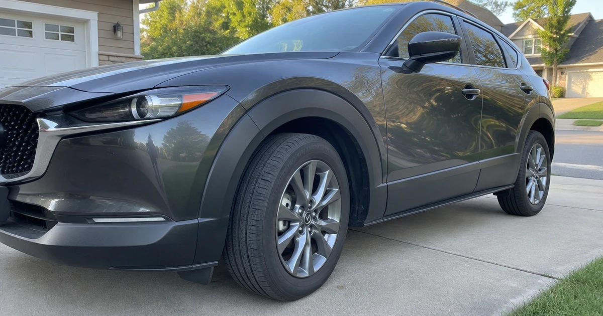 A Mazda CX-30 parked on a driveway with tires for Mazda CX-30 visible in natural light
