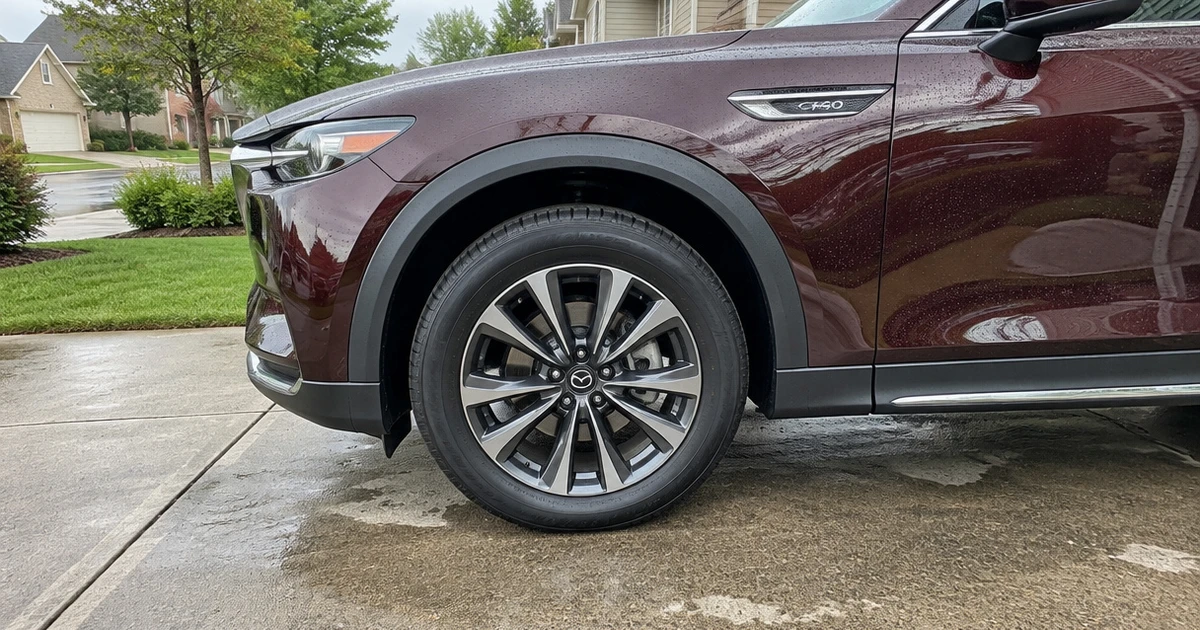 All-season tires for Mazda CX-90 sit fitted on an SUV in a quiet driveway