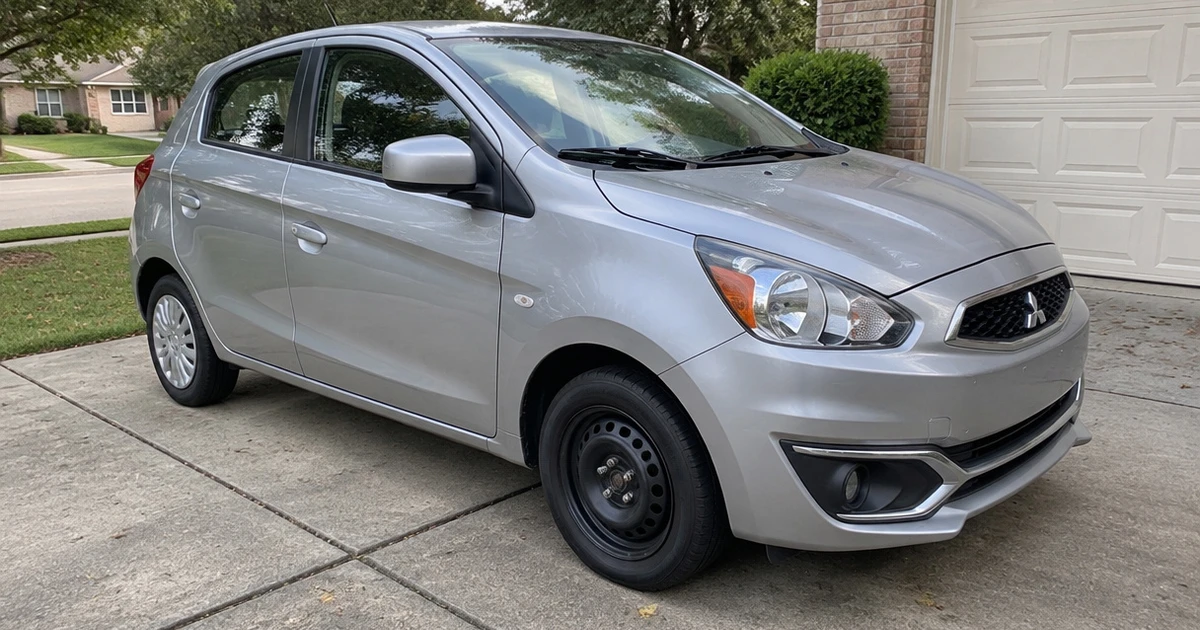 A Mitsubishi Mirage parked in a driveway with tires for Mitsubishi Mirage fitted