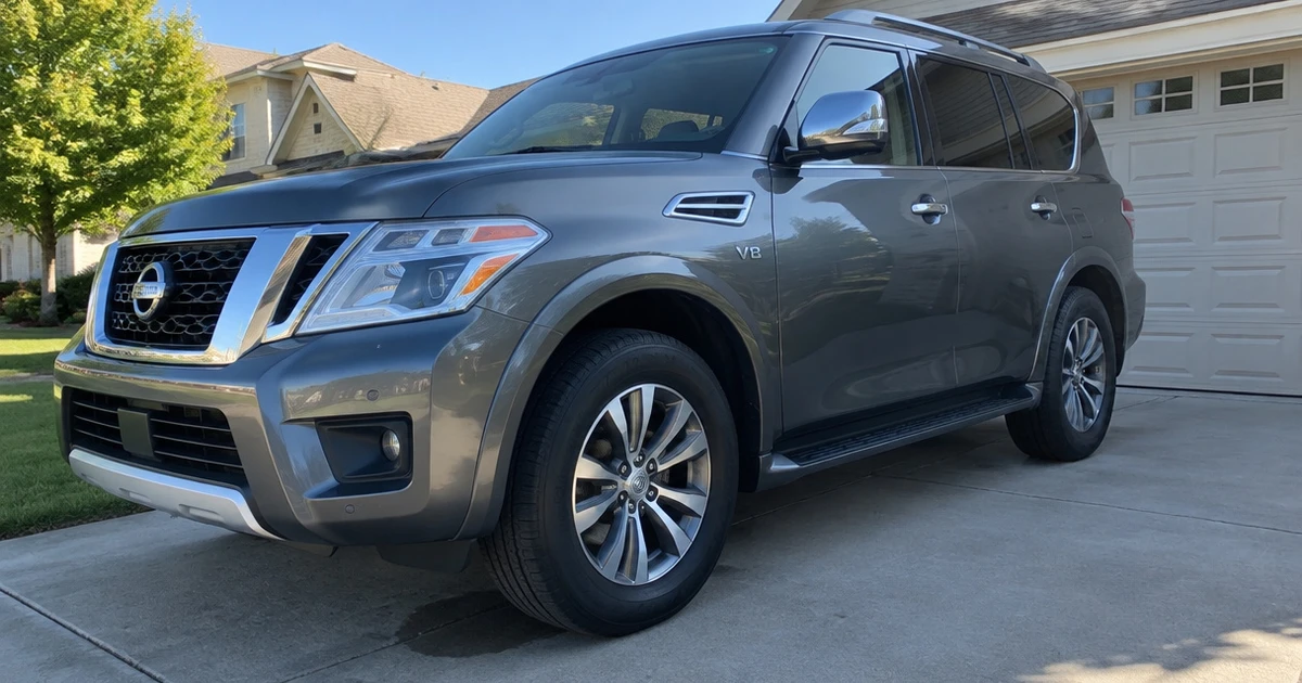 The tires for Nissan Armada are visible on a parked SUV in a quiet driveway