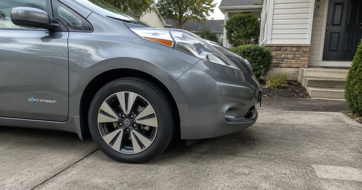 A Nissan Leaf parked on a driveway shows tires for Nissan Leaf use