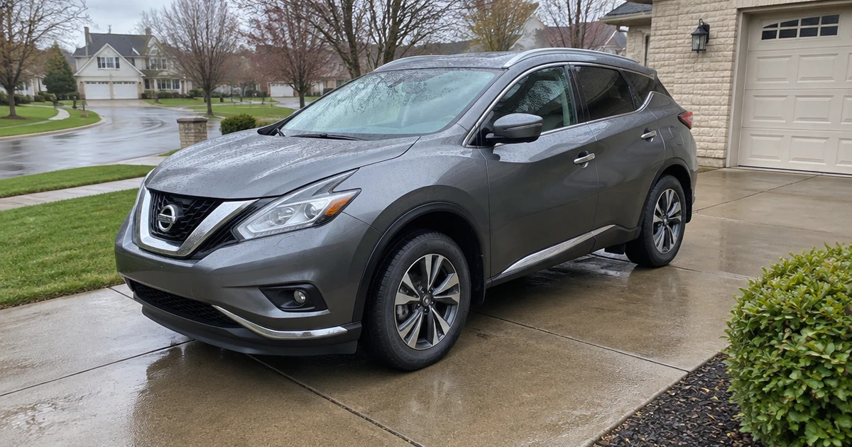 A Nissan Murano sits on a neighborhood street with tires for Nissan Murano visible