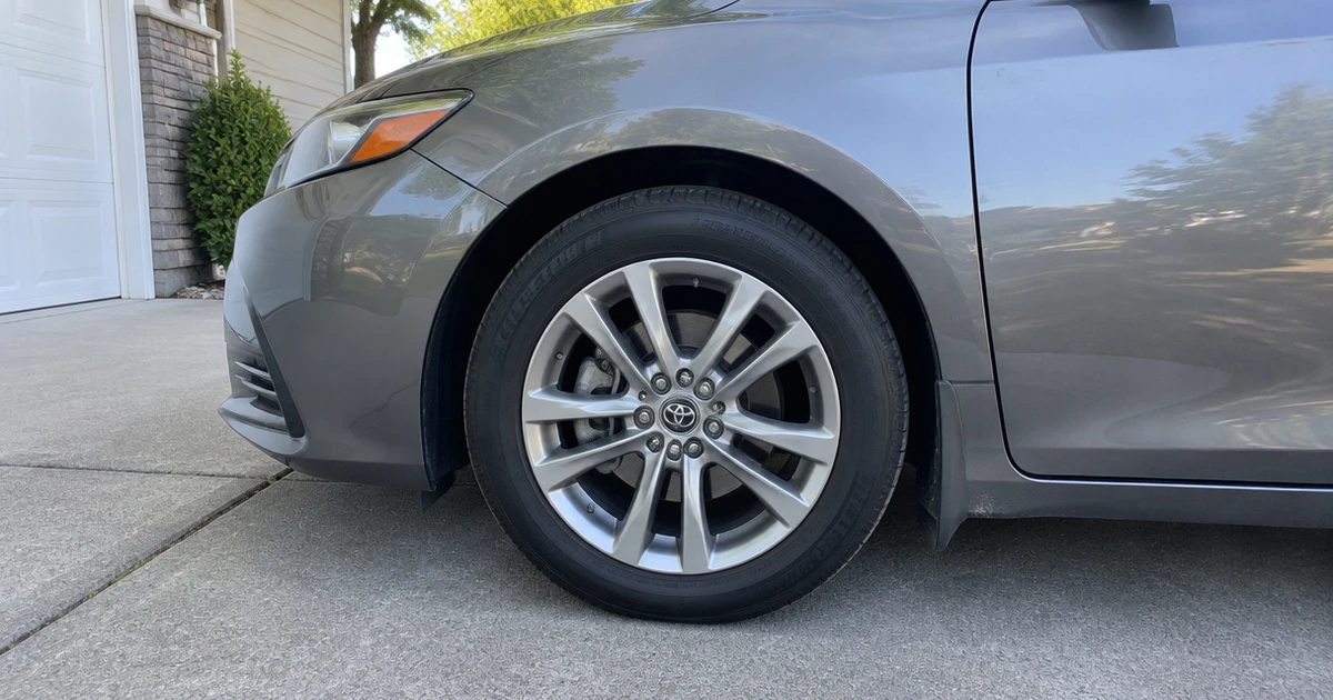 Tires for Toyota Camry fitted to a sedan parked on a quiet residential driveway