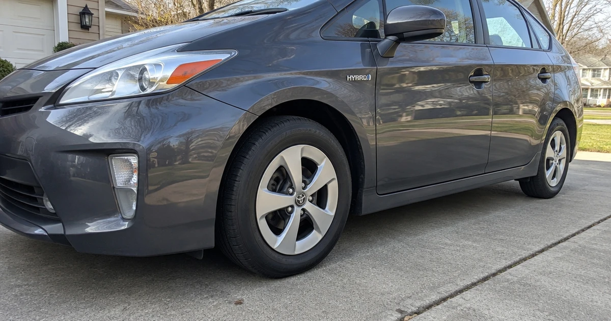 A Toyota Prius parked outside shows a tire for Toyota Prius in clear natural daylight