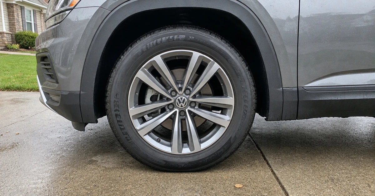 A Volkswagen Atlas parked outdoors with tires for Volkswagen Atlas visible on its front wheel