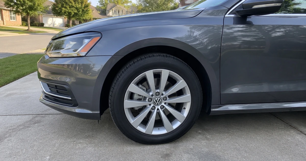 A Volkswagen Passat parked on a driveway with tires for Volkswagen Passat fitted