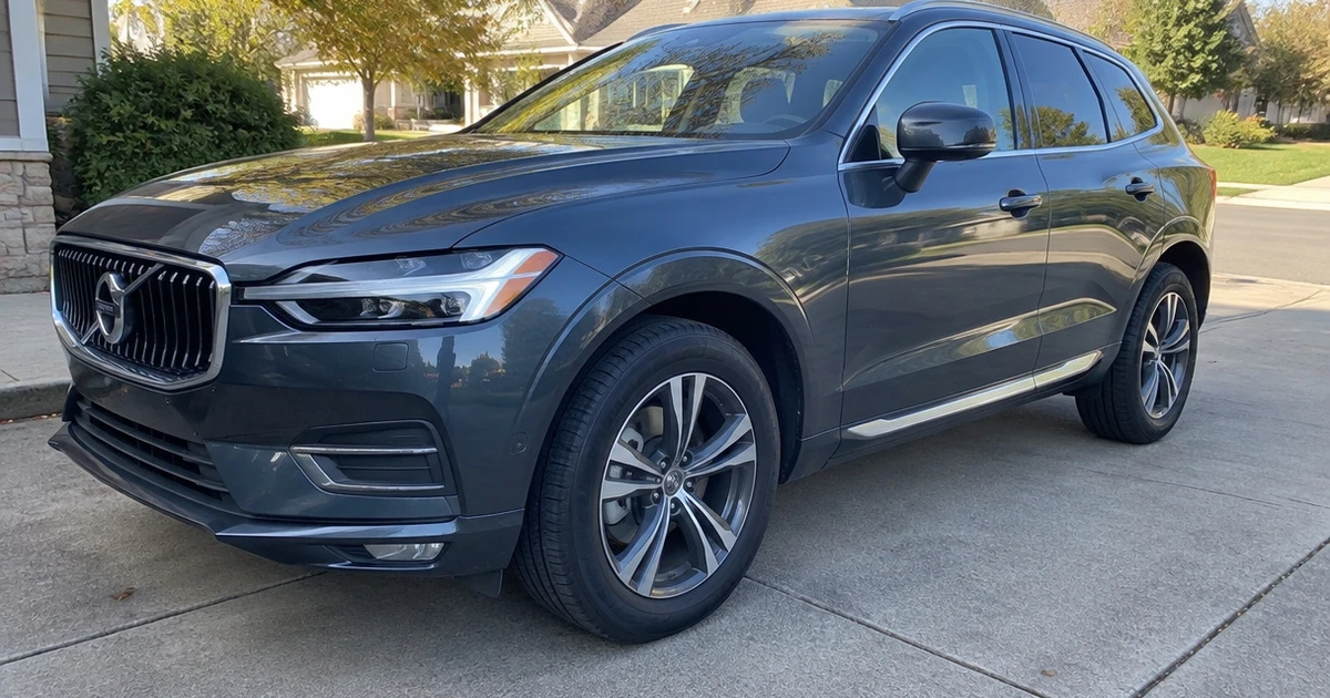 A Volvo XC60 parked on a driveway with tires for Volvo XC60 clearly visible