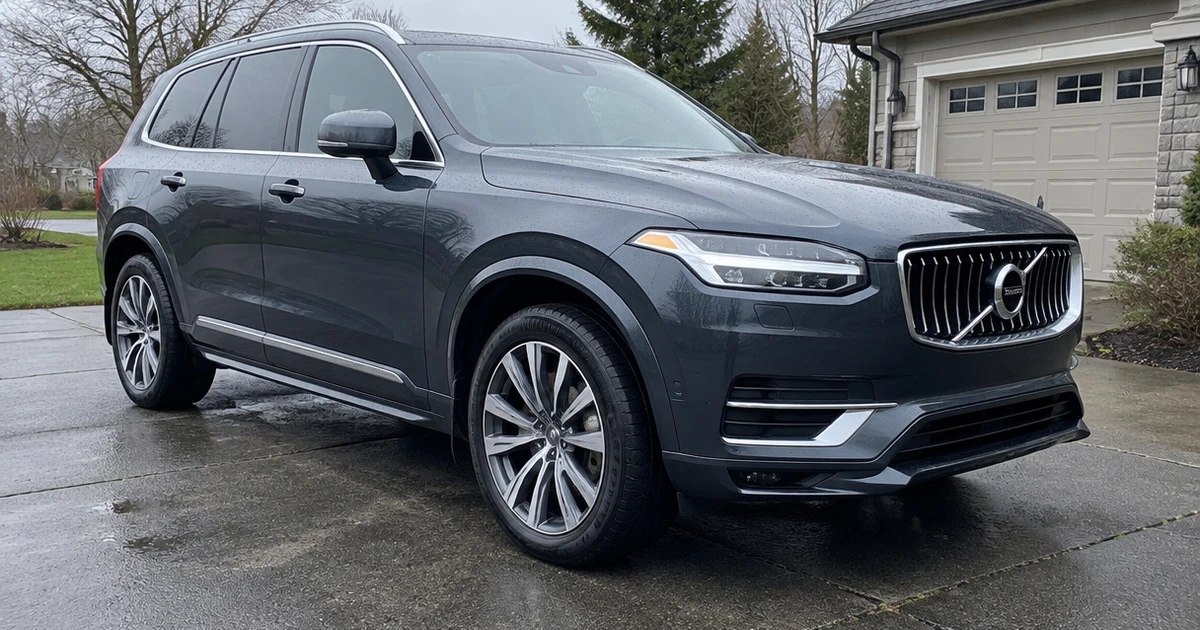 A Volvo XC90 parked by a wet road shows a tire for Volvo XC90 clearly